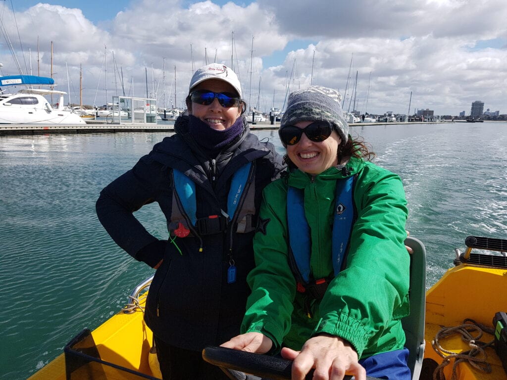 Women smiling on a Powerboat on the water